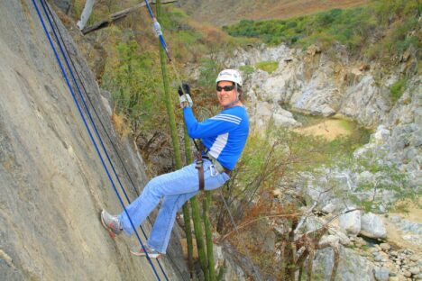 Nicholas Meyler ziplining over mountain landscapes
