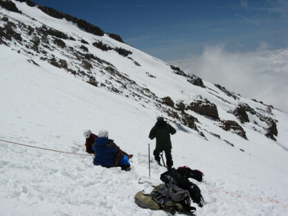 Nicholas Meyler climbing a rocky mountain ridge