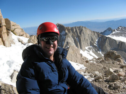 Nicholas Meyler climbing a rocky mountain ridge
