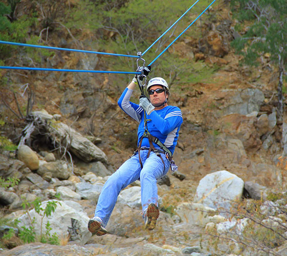 Nicholas Meyler ziplining during an adventure expedition